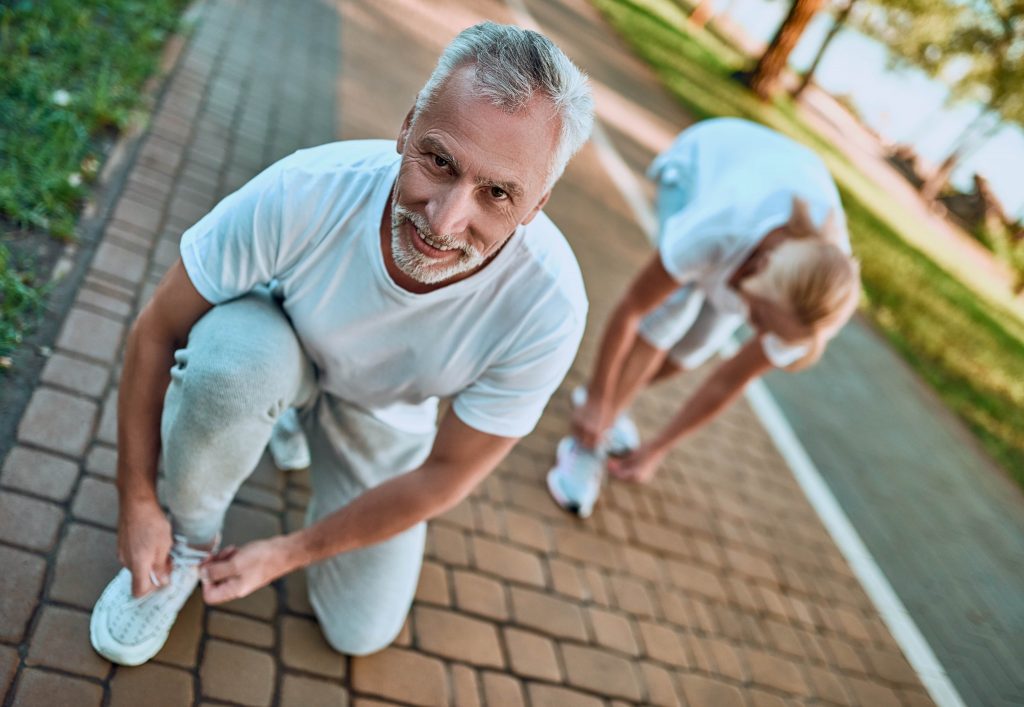 mature couple setting out on a jog